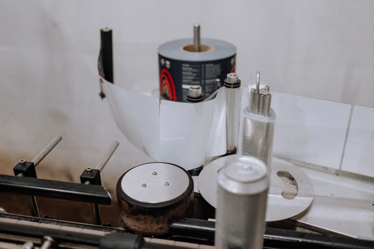Label roll feeding through a labelling machine on a production line