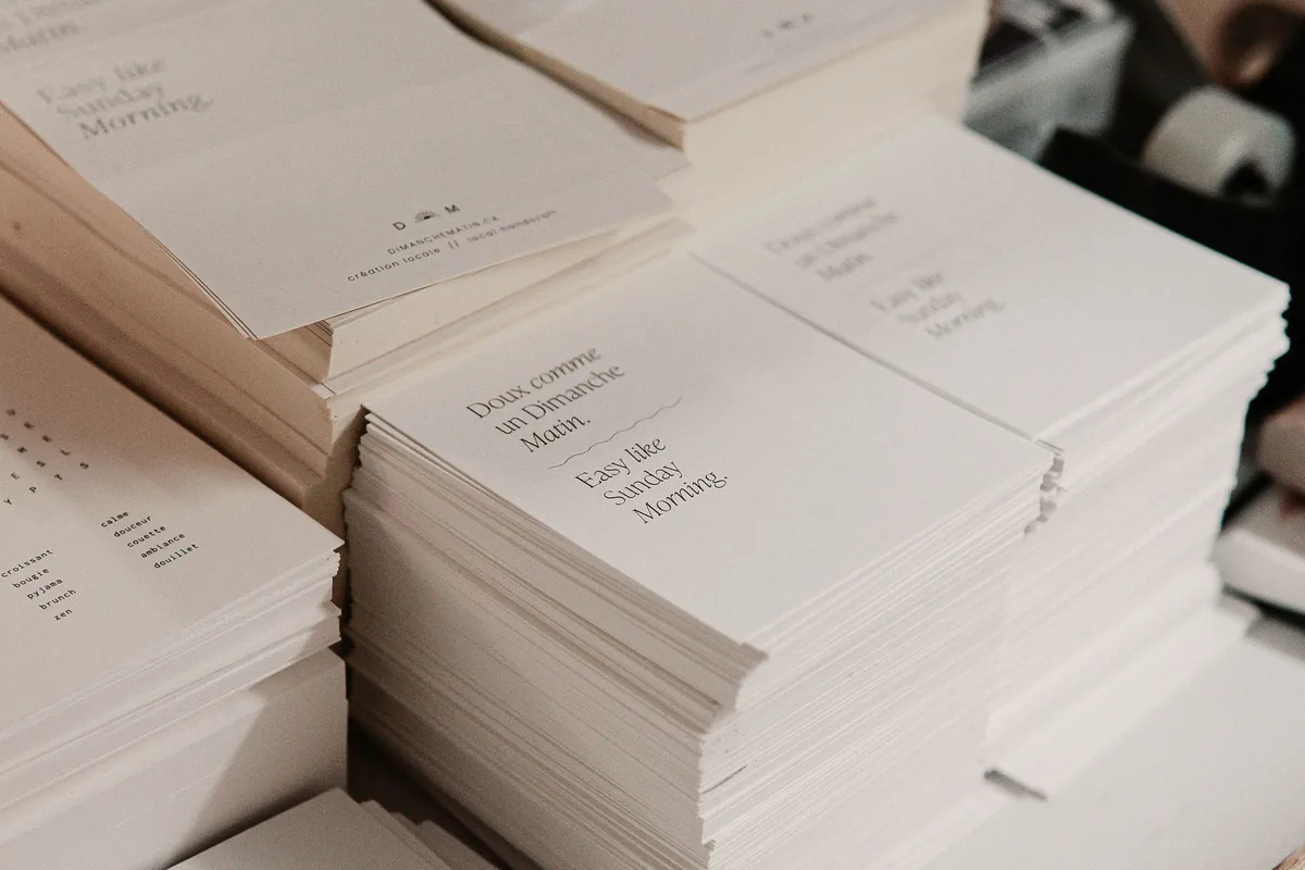 Stacks of printed leaflets piled on a studio table